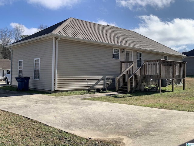 back of house featuring a deck and a yard