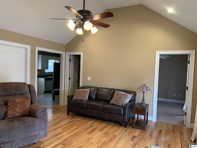 living room featuring light hardwood / wood-style floors, high vaulted ceiling, and ceiling fan