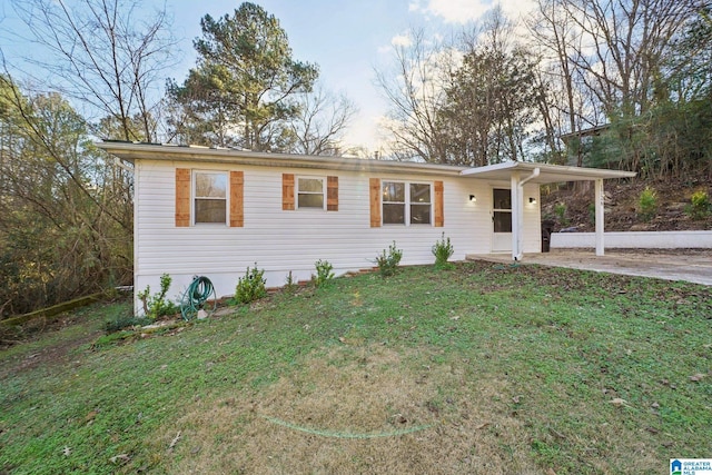 ranch-style house with a carport and a front yard