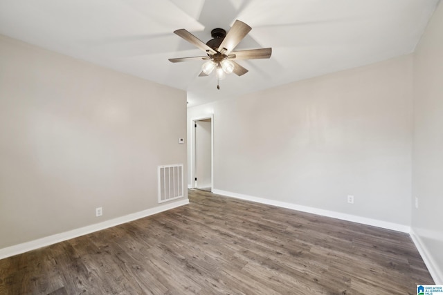 spare room with ceiling fan and dark hardwood / wood-style floors