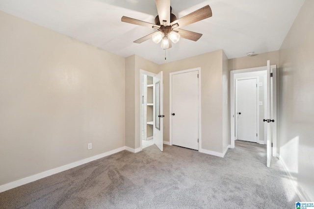 unfurnished bedroom featuring ceiling fan and light colored carpet