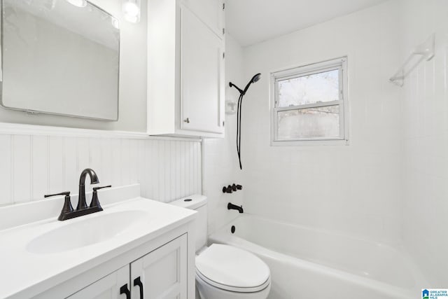 full bathroom featuring vanity, tiled shower / bath combo, and toilet