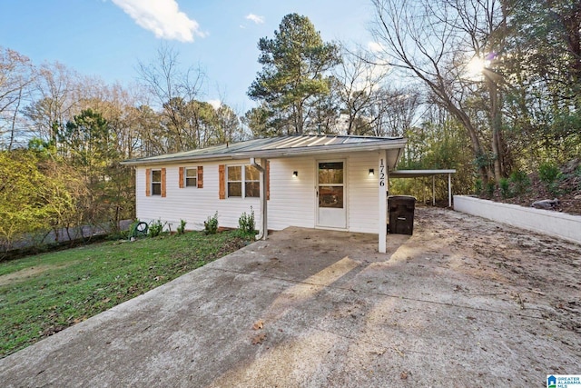 single story home with a front yard and a carport