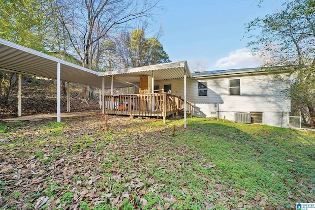 rear view of house with a carport, cooling unit, and a wooden deck