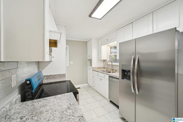 kitchen featuring sink, stainless steel appliances, tasteful backsplash, light stone counters, and white cabinets