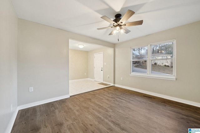 empty room featuring ceiling fan and dark wood-type flooring