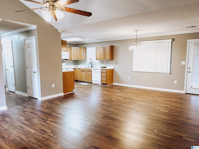 kitchen with white appliances, dark wood-type flooring, crown molding, a textured ceiling, and decorative light fixtures