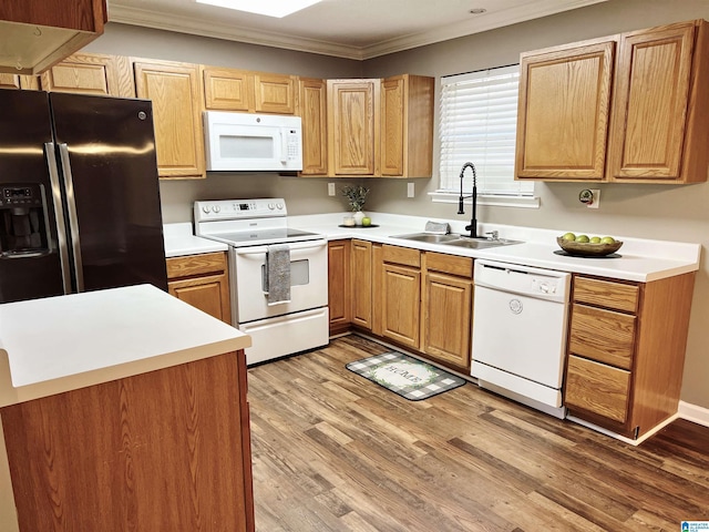 kitchen featuring white appliances, light hardwood / wood-style flooring, crown molding, and sink