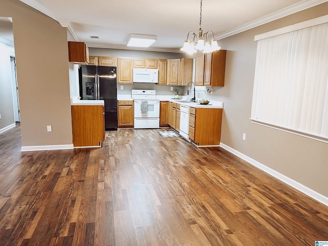 kitchen with sink, an inviting chandelier, decorative light fixtures, white appliances, and ornamental molding