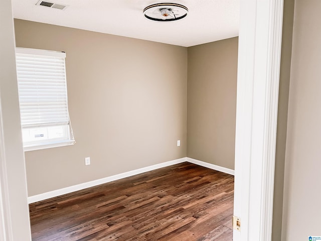 spare room with dark wood-type flooring