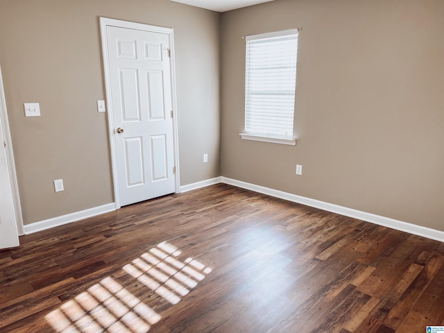 spare room with dark wood-type flooring