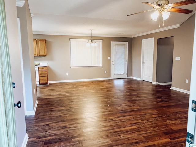 interior space featuring ceiling fan with notable chandelier, dark hardwood / wood-style floors, and ornamental molding