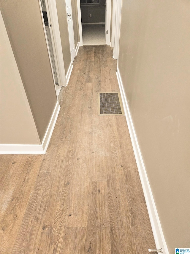 corridor with light wood-type flooring