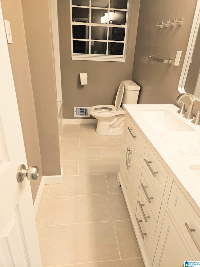 bathroom featuring tile patterned flooring, vanity, and toilet