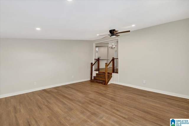 unfurnished living room featuring ceiling fan and wood-type flooring