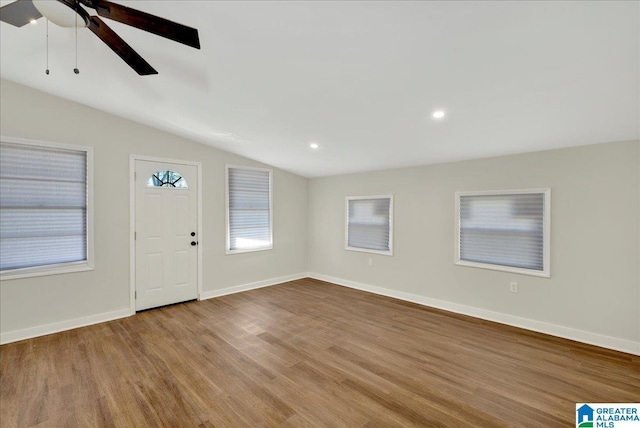 entrance foyer featuring vaulted ceiling, ceiling fan, and hardwood / wood-style flooring