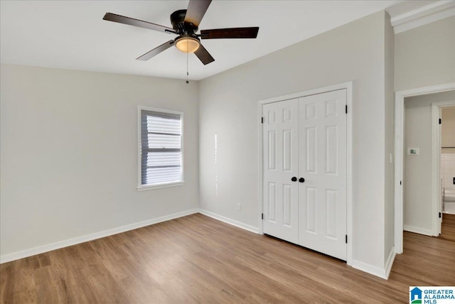 unfurnished bedroom with ceiling fan, a closet, and light hardwood / wood-style floors