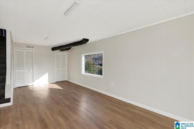 unfurnished room with dark hardwood / wood-style flooring and crown molding