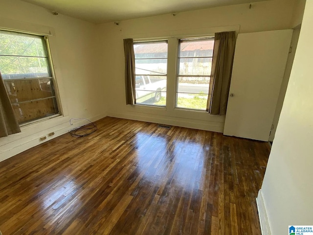 unfurnished room featuring dark wood-type flooring