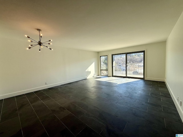 spare room featuring a notable chandelier