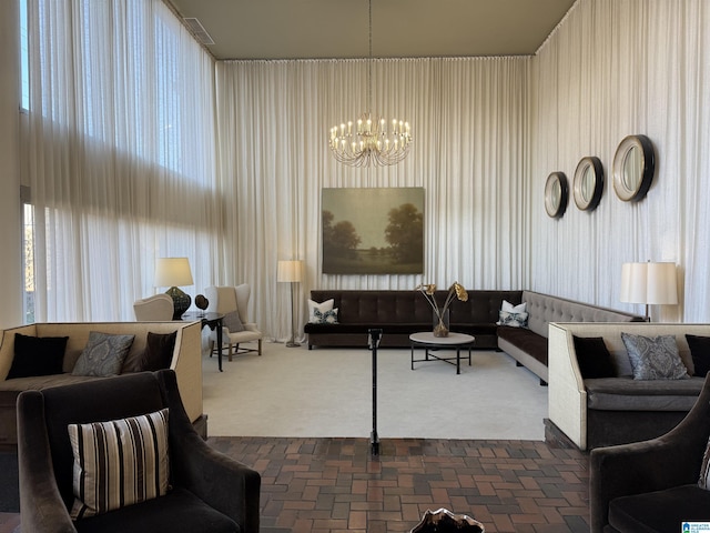 carpeted living room with a chandelier and a high ceiling