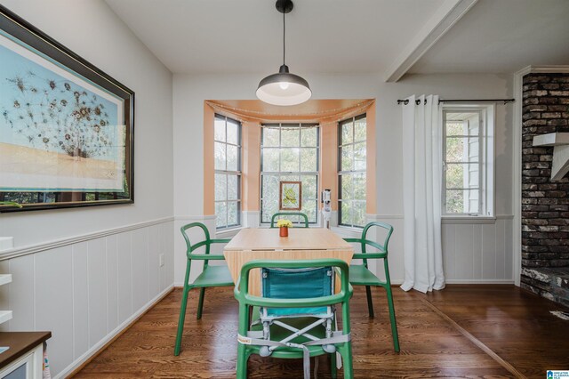 dining space featuring a fireplace and dark hardwood / wood-style floors