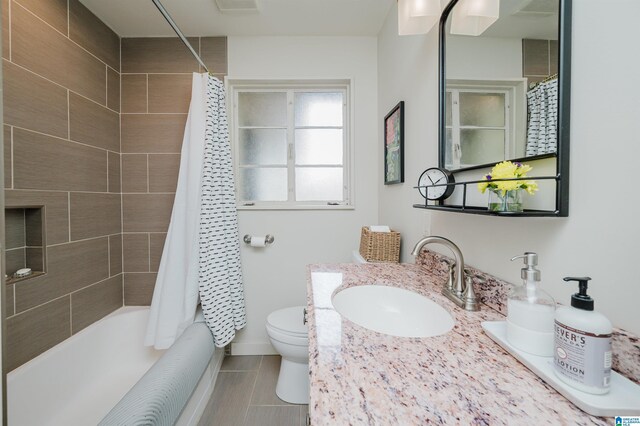 full bathroom with tile patterned floors, vanity, toilet, and shower / bathtub combination with curtain