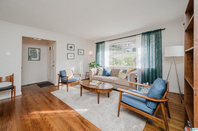 living room with hardwood / wood-style floors and crown molding