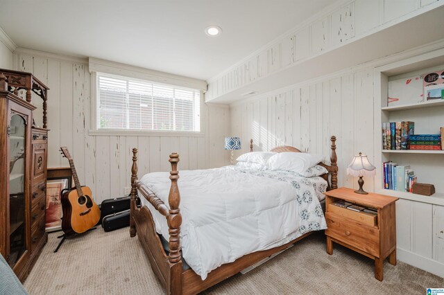 carpeted bedroom with ornamental molding