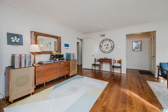 interior space with dark wood-type flooring and ornamental molding