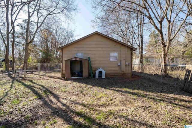 back of property featuring a shed