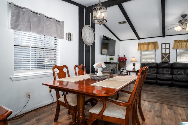 dining room featuring dark hardwood / wood-style flooring, lofted ceiling with beams, plenty of natural light, and ceiling fan