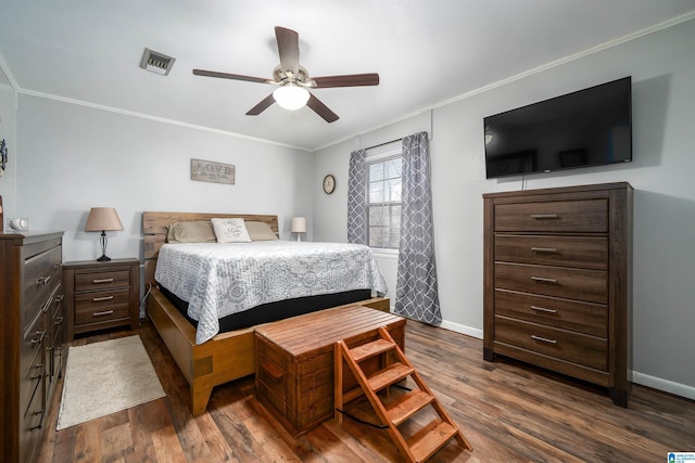 bedroom featuring crown molding, ceiling fan, and dark wood-type flooring