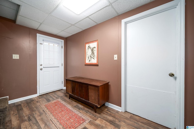 foyer featuring dark hardwood / wood-style floors and a drop ceiling