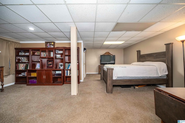 carpeted bedroom with a drop ceiling