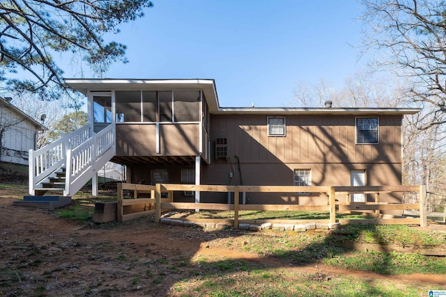 rear view of house featuring a sunroom