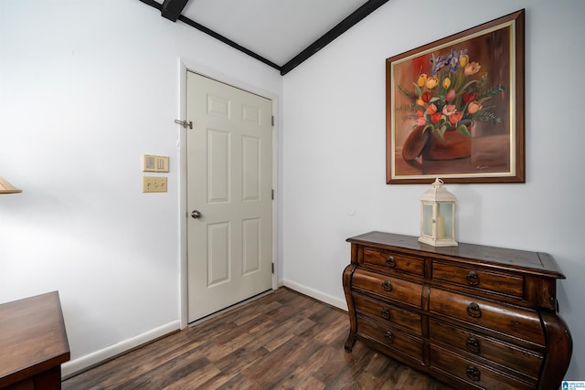 entrance foyer featuring crown molding, lofted ceiling, and dark wood-type flooring