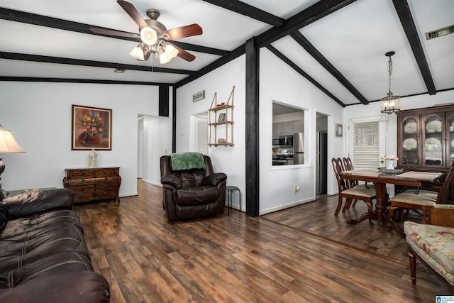 living room featuring lofted ceiling with beams, dark hardwood / wood-style flooring, and ceiling fan with notable chandelier