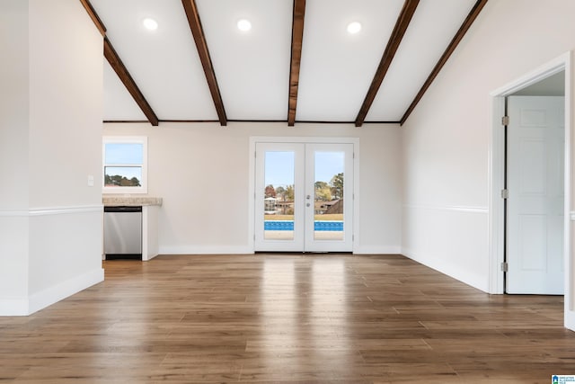 unfurnished living room with french doors, dark hardwood / wood-style flooring, and plenty of natural light