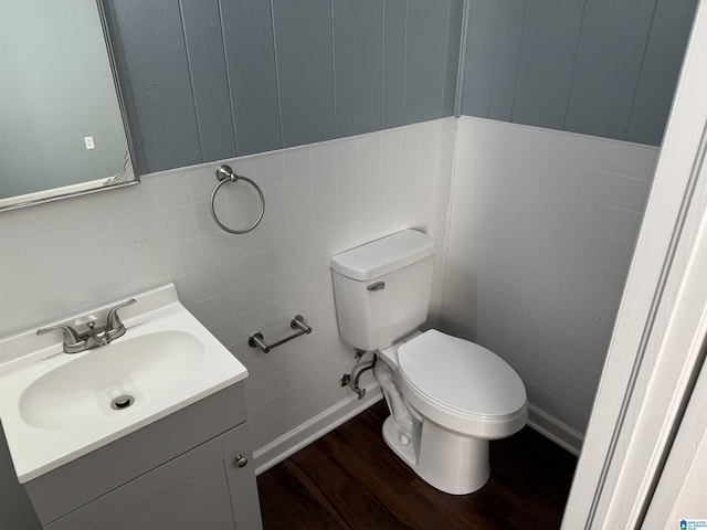 bathroom featuring toilet, vanity, and hardwood / wood-style flooring