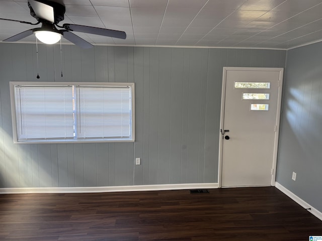 entrance foyer with ornamental molding, ceiling fan, and dark wood-type flooring