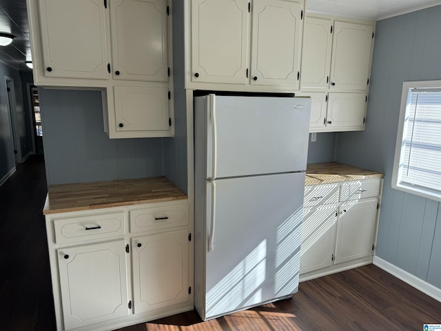 kitchen featuring white cabinetry, white fridge, and dark hardwood / wood-style floors