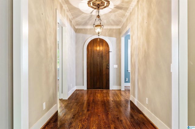 foyer entrance with dark hardwood / wood-style floors and crown molding