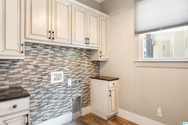 laundry area with washer hookup, light hardwood / wood-style flooring, cabinets, and hookup for an electric dryer