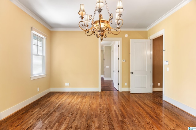 unfurnished room featuring a chandelier, dark hardwood / wood-style floors, and ornamental molding