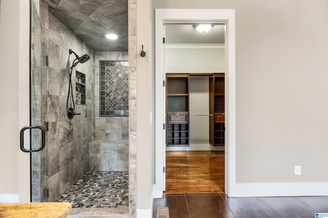 bathroom featuring tile patterned flooring and a shower with shower door