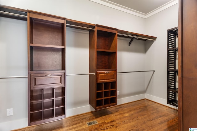 spacious closet with dark hardwood / wood-style floors