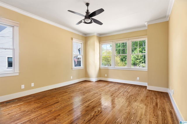 empty room with light hardwood / wood-style floors, ceiling fan, and ornamental molding