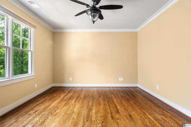 unfurnished room featuring ceiling fan, wood-type flooring, and ornamental molding