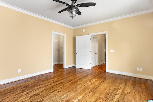 empty room with hardwood / wood-style flooring, ceiling fan, and ornamental molding